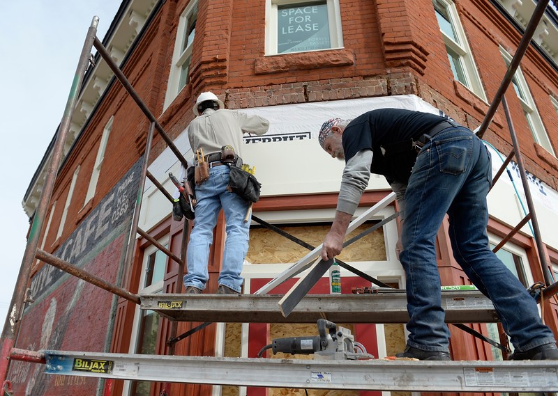 DENVER, CO - MARCH 29: Mitch Seeley, left, and Russell Pope of Spectrum General Contractors, continue work on the exterior of the building. State tax credits are going to companies that are rehabilitating historic buildings around the state, like the former Rice's Tap House in the historic Five Points neighborhood. This funding is expected to help increase development in surrounding areas. (Photo by Kathryn Scott Osler/The Denver Post)